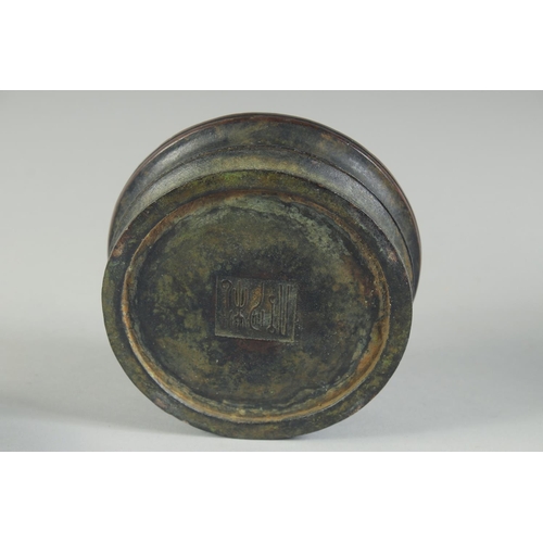 1200 - A CHINESE CIRCULAR BRONZE CENSER AND COVER. 4.5ins diameter.