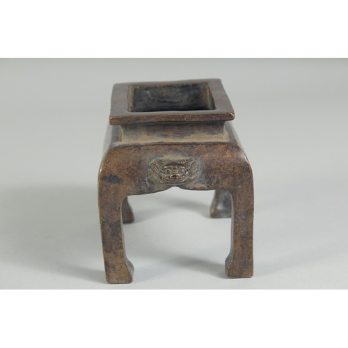 1205 - A CHINESE BRONZE RECTANGULAR CENSER on legs. 5ins high.