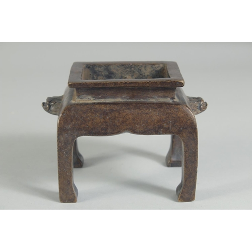 1205 - A CHINESE BRONZE RECTANGULAR CENSER on legs. 5ins high.