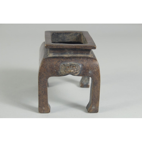 1205 - A CHINESE BRONZE RECTANGULAR CENSER on legs. 5ins high.