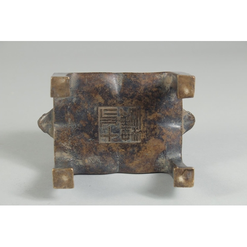 1205 - A CHINESE BRONZE RECTANGULAR CENSER on legs. 5ins high.