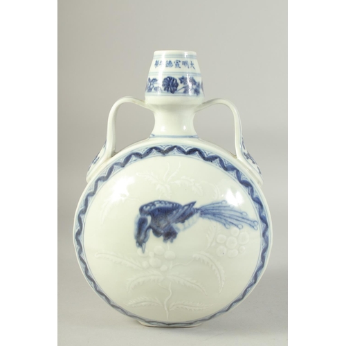 1212 - A CHINESE BLUE AND WHITE TWIN HANDLE MOON FLASK, decorated to each side with a bird. 29.5ins high.... 