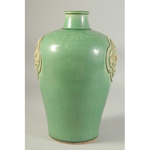 1215 - A CHINESE GREEN GLAZE JIZHOU VASE, with two relief floral panels. 29.5cm high.