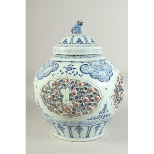 1225 - A LARGE CHINESE BLUE, WHITE AND UNDERGLAZE RED PORCELAIN JAR AND COVER, with relief panels depicting... 