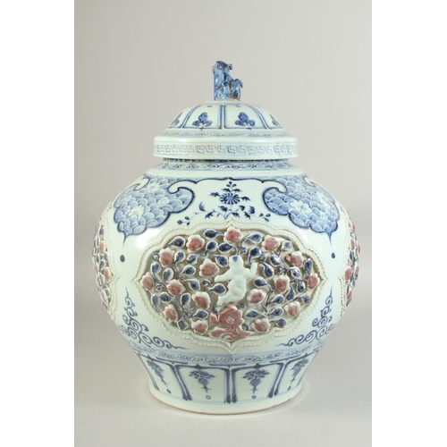 1225 - A LARGE CHINESE BLUE, WHITE AND UNDERGLAZE RED PORCELAIN JAR AND COVER, with relief panels depicting... 