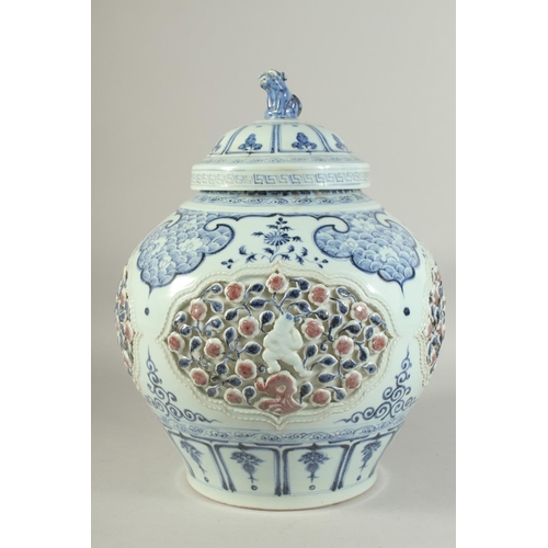 1225 - A LARGE CHINESE BLUE, WHITE AND UNDERGLAZE RED PORCELAIN JAR AND COVER, with relief panels depicting... 