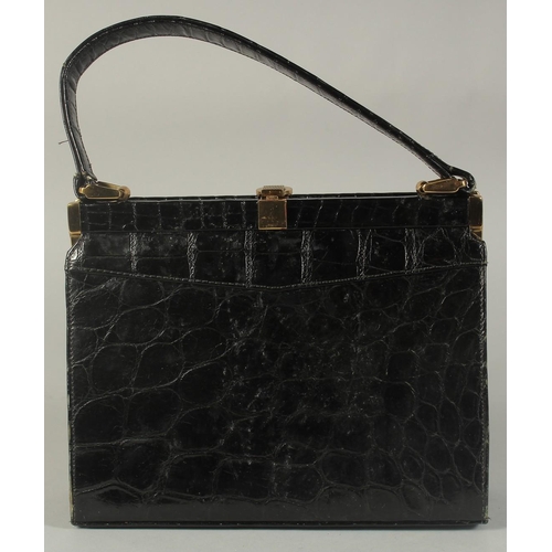 1313 - A 1950's - 1960's BLACK CROCODILE SKIN EVENING BAG, 8.5ins long with single handle.