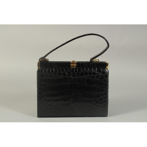 1313 - A 1950's - 1960's BLACK CROCODILE SKIN EVENING BAG, 8.5ins long with single handle.