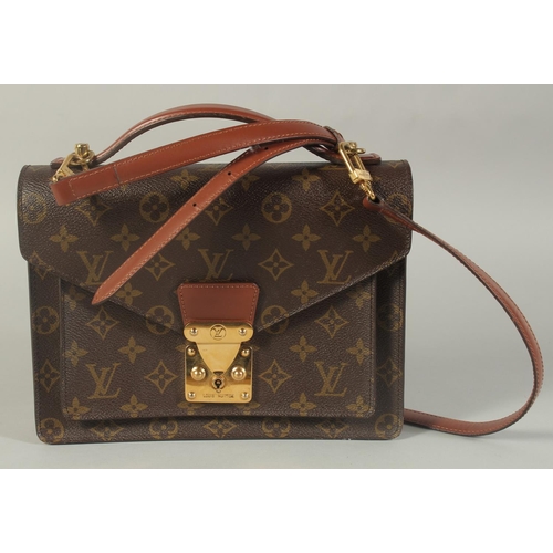 1314 - A LOUIS VUITTON LEATHER BAG with long and short handles. 9.5ins long.