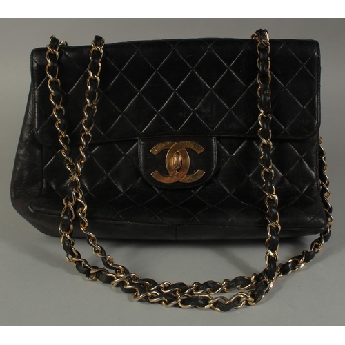 1320 - A LARGE CHANEL BLACK PADDED LEATHER BAG (USED), 11.5ins long with long entwined gilt metal and leath... 