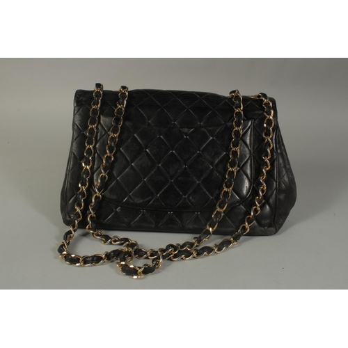 1320 - A LARGE CHANEL BLACK PADDED LEATHER BAG (USED), 11.5ins long with long entwined gilt metal and leath... 