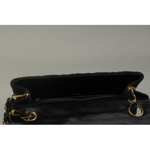 1321 - A SMALL CHANEL PADDED BLACK EVENING BAG 6.5ins long with entwined gilt metal and leather chain, 20in... 