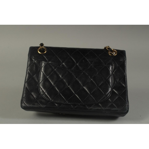 1322 - A SMALL CHANEL PADDED BLACK LEATHER BAG, 7.5ins long with entwined gilt and leather strap, 14ins lon... 