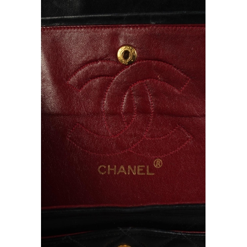 1322 - A SMALL CHANEL PADDED BLACK LEATHER BAG, 7.5ins long with entwined gilt and leather strap, 14ins lon... 