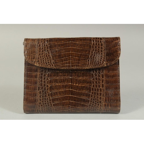 1329 - AN A R WEST GERMANY, BROWN CROCODILE SKIN HANDBAG, 6.5ins long, with rope handles.