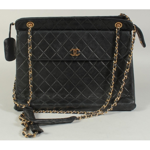 1335 - A LARGE CHANEL BLACK PADDED LEATHER BAG, 13ins long, 10ins high, with entwined gilt metal and leathe... 