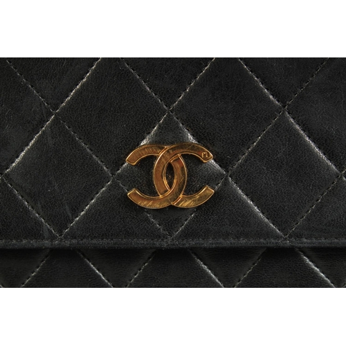 1335 - A LARGE CHANEL BLACK PADDED LEATHER BAG, 13ins long, 10ins high, with entwined gilt metal and leathe... 