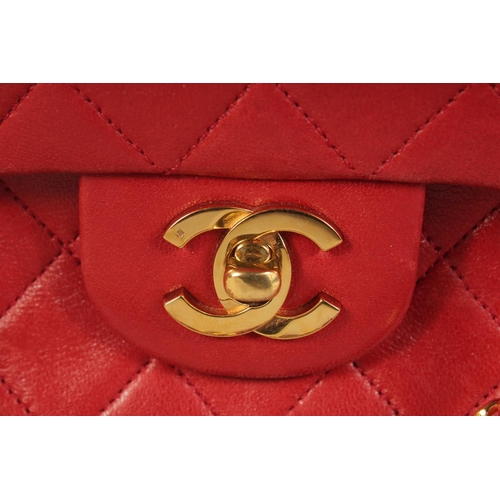 1344 - A CHANEL PADDED LEATHER RED HANDBAG, with entwined leather and gilt straps. 9ins wide.