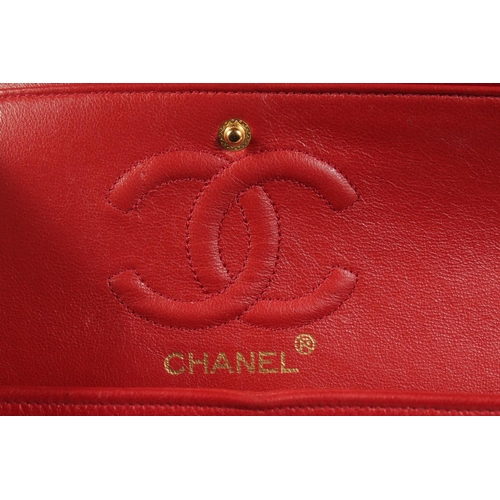 1344 - A CHANEL PADDED LEATHER RED HANDBAG, with entwined leather and gilt straps. 9ins wide.