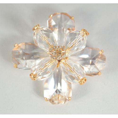 1354 - A LARGE CHANEL EIGHT PETAL FLOWER BROOCH with CC in diamante, in a Chanel box. 4.5cm diameter.