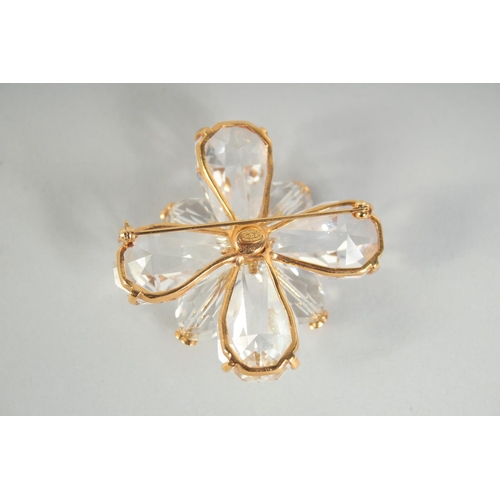 1354 - A LARGE CHANEL EIGHT PETAL FLOWER BROOCH with CC in diamante, in a Chanel box. 4.5cm diameter.