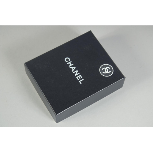 1354 - A LARGE CHANEL EIGHT PETAL FLOWER BROOCH with CC in diamante, in a Chanel box. 4.5cm diameter.