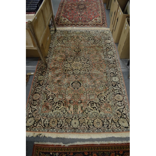 1003 - A PERSIAN RUG with floral decoration. 180cm x 120cm.