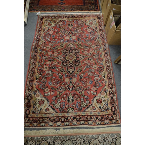 1004 - A PERSIAN RUG, pink ground with floral decoration 168cm x 103cm