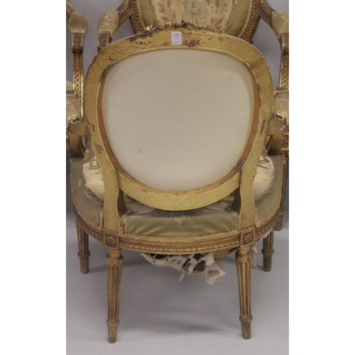 1016 - A GOOD SET OF FOUR LOUIS XVI 19TH CENTURY GILT ARMCHAIRS with oval backs and open arms, padded seats... 