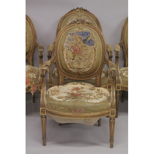 1016 - A GOOD SET OF FOUR LOUIS XVI 19TH CENTURY GILT ARMCHAIRS with oval backs and open arms, padded seats... 