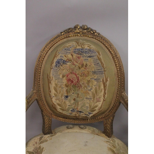 1016 - A GOOD SET OF FOUR LOUIS XVI 19TH CENTURY GILT ARMCHAIRS with oval backs and open arms, padded seats... 