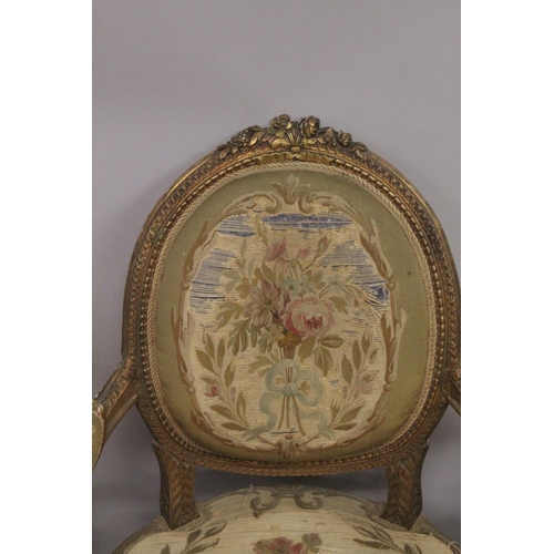 1016 - A GOOD SET OF FOUR LOUIS XVI 19TH CENTURY GILT ARMCHAIRS with oval backs and open arms, padded seats... 