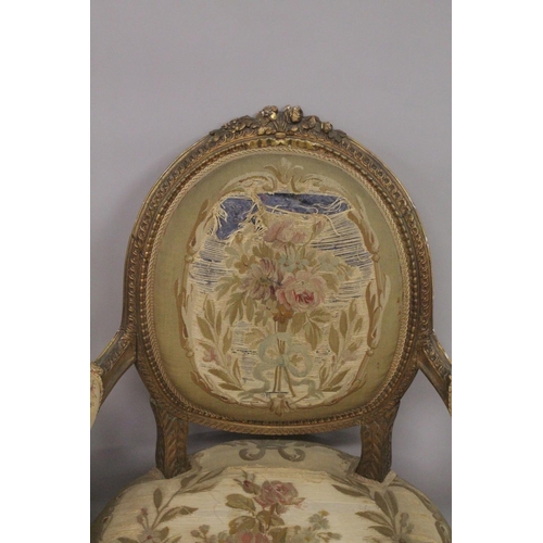 1016 - A GOOD SET OF FOUR LOUIS XVI 19TH CENTURY GILT ARMCHAIRS with oval backs and open arms, padded seats... 