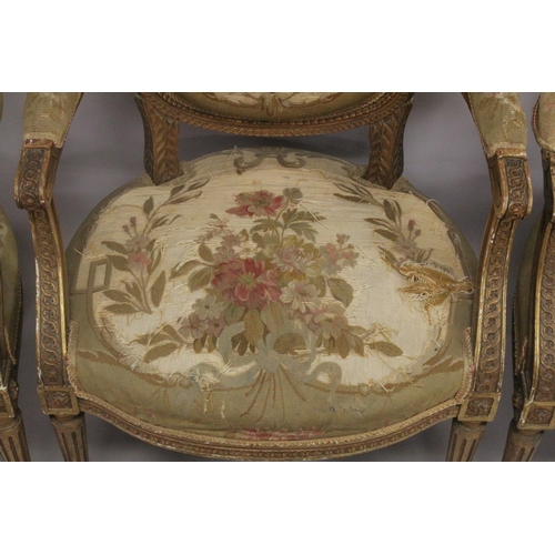 1016 - A GOOD SET OF FOUR LOUIS XVI 19TH CENTURY GILT ARMCHAIRS with oval backs and open arms, padded seats... 