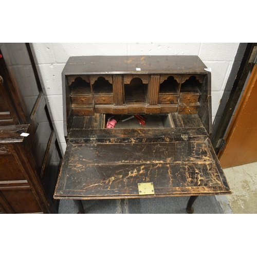 1036 - AN 18TH CENTURY CARVED OAK BUREAU on stand. 2ft 7ins wide, 3ft 4ins high.