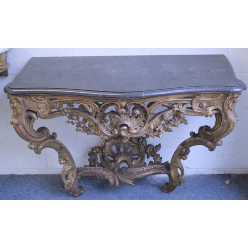 1038 - A SUPERB NEAR PAIR OF 18TH CENTURY ITALIAN CARVED AND PIERCED GILTWOOD CONSOLE TABLES with marble to... 