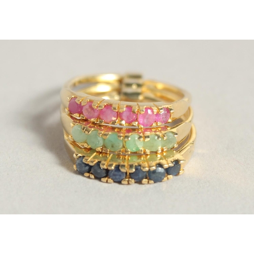 1807 - A SILVER AND 18 CT GOLD PLATED SAPPHIRE RUBY AND EMERALD STACK RING.