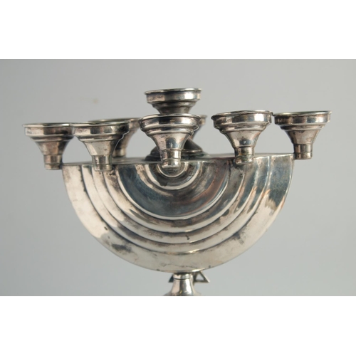 1957 - A GOOD JEWISH SILVER MENORAH on a circular base. 12ins high.