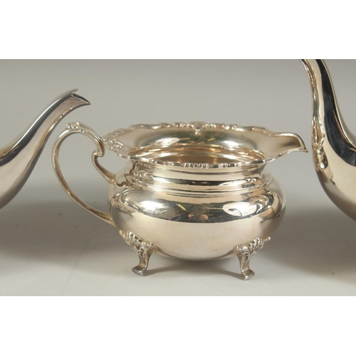 1958 - A VERY GOOD FOUR PIECE SILVER CIRCULAR TEA SET of pie crust design with shell mounts, comprising: te... 