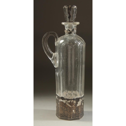 1960 - A DUTCH GLASS LIQUEUR DECANTER AND STOPPER with carrying handle and silver top and base. 11.5ins hig... 