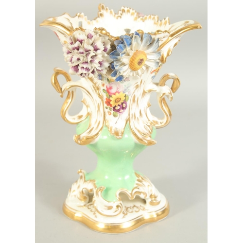 1118 - A GOOD LARGE FLOWER ENCRUSTED URN with gilt decoration, pierced handles and painted with flowers. 9i... 