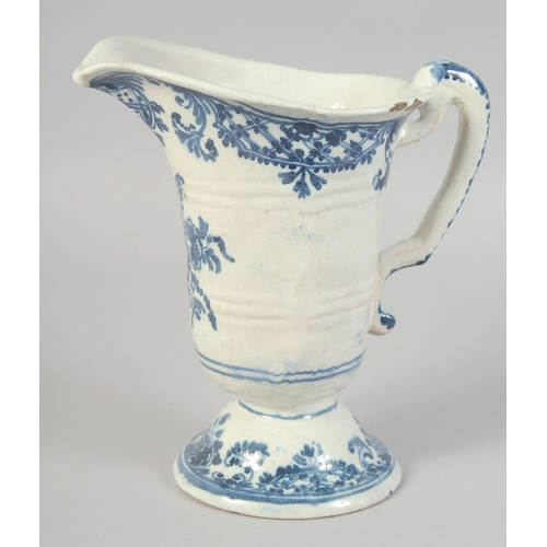 1132 - AN 18TH CENTURY ROUEN BLUE AND WHITE HELMET SHAPED JUG. 8ins high.