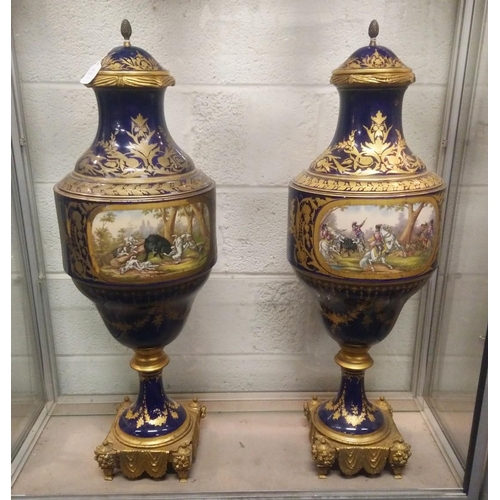 1149 - A SUPERB LARGE PAIR OF 19TH CENTURY SEVRES PORCELAIN URNS AND COVERS, rich blue ground with gilt dec... 