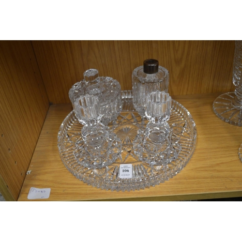 106 - Cut glass circular dressing table tray with pair of candlesticks, perfume bottle and powder bowl and... 