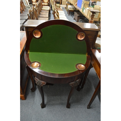 275 - A mahogany demi-lune fold over card table with carved cabriole legs.