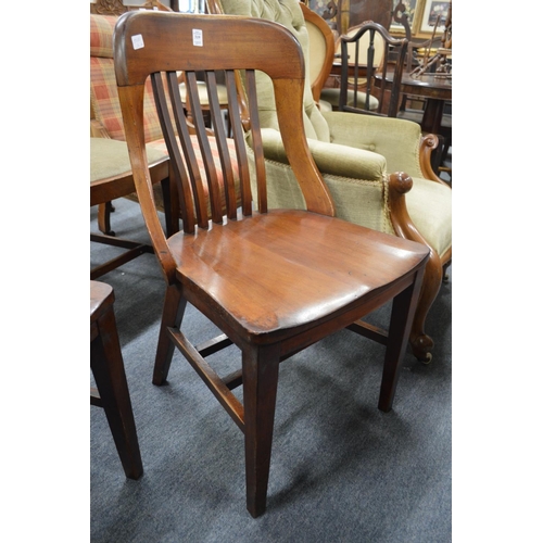 319 - A pair of Edwardian mahogany chairs with vertical slat backs, solid seats on tapering legs.