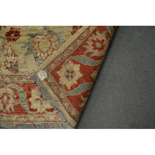 351 - A Persian design rug cream ground with red and blue floral decoration, 148cm x 108cm.