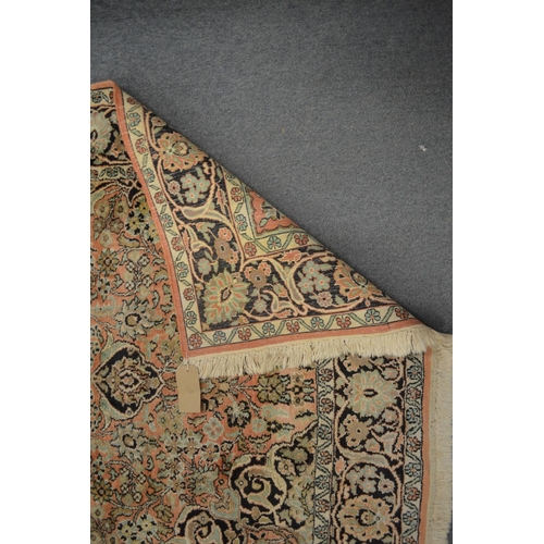 359 - A Persian rug, pink ground with stylised decoration, 180cm x 120cm.