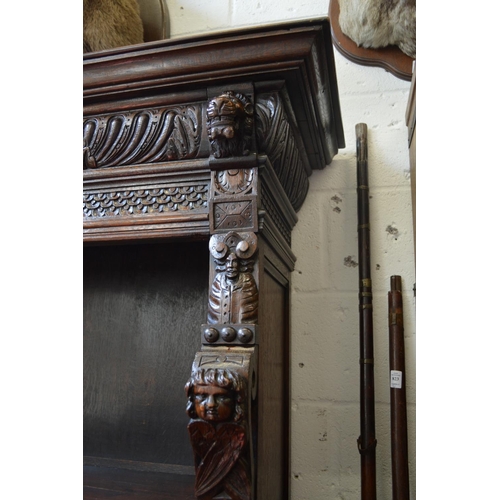 398 - A 17th century style carved oak open bookcase.