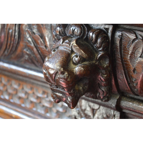 398 - A 17th century style carved oak open bookcase.